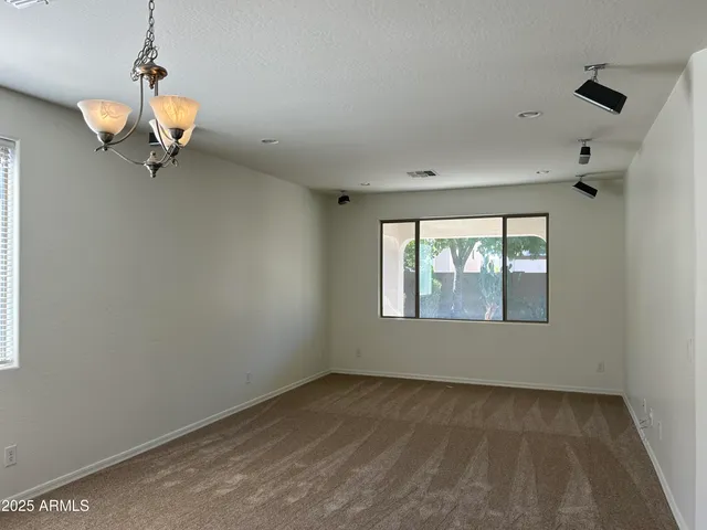 a view of a room with a window and a ceiling fan