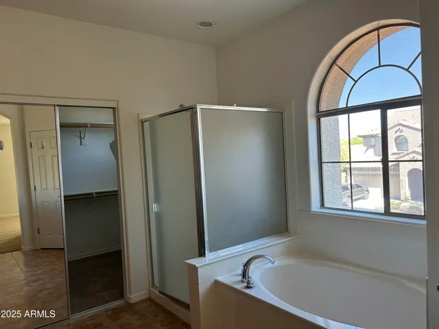 a bathroom with a bathtub and a window