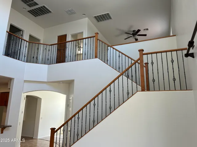 a view of staircase with railing and white walls