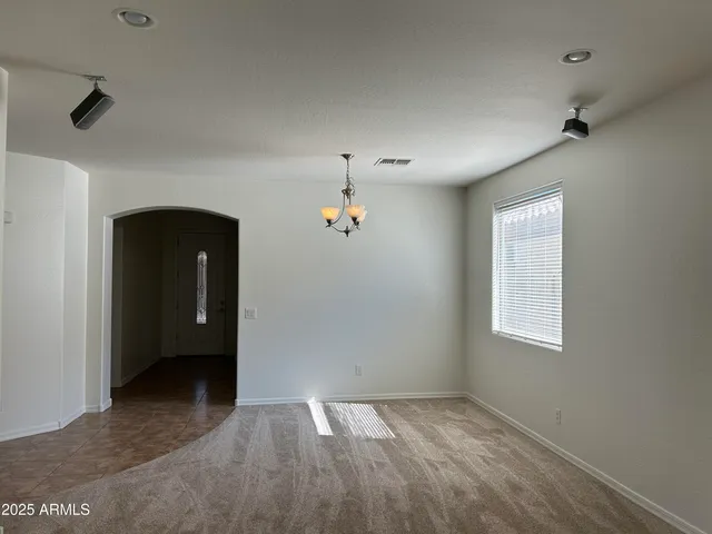 an empty room with closet and windows