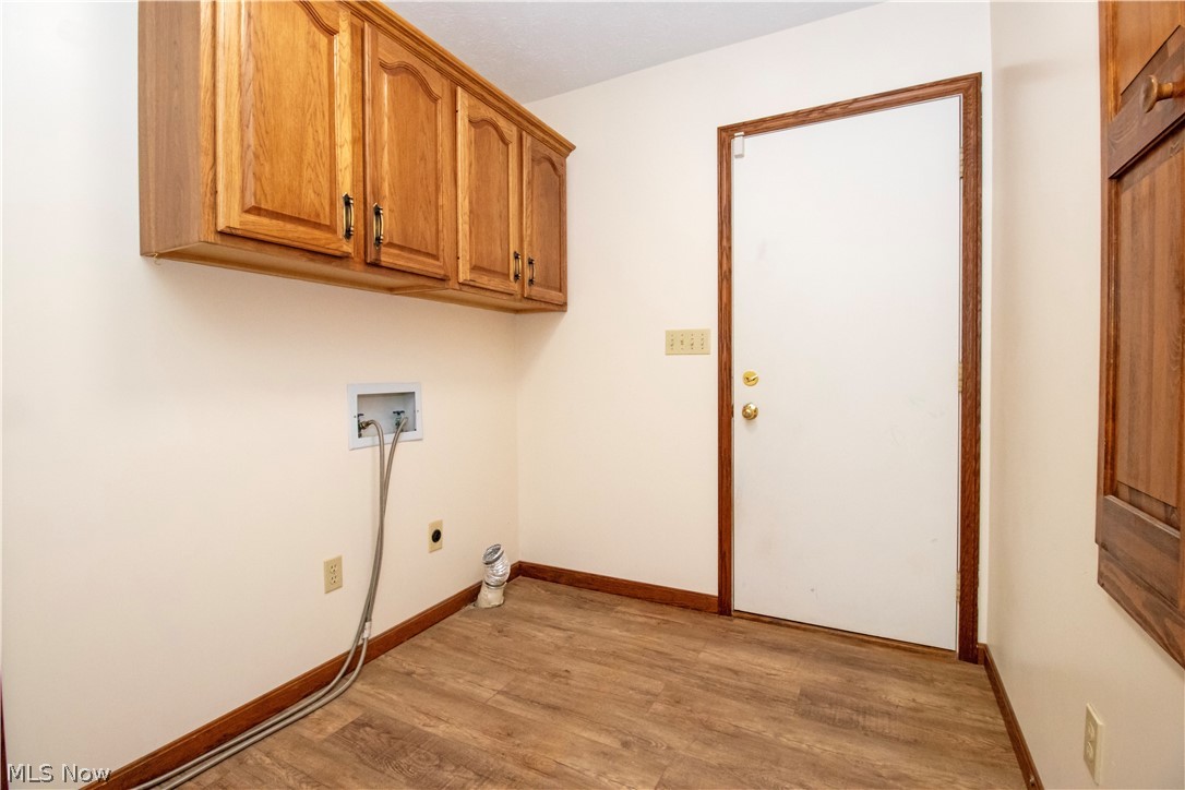 391 Cardinal Drive Rittman, OH 44270 - Photo 22 of 33 Washroom featuring washer hookup, cabinets, hookup for an electric dryer, and light wood-type flooring