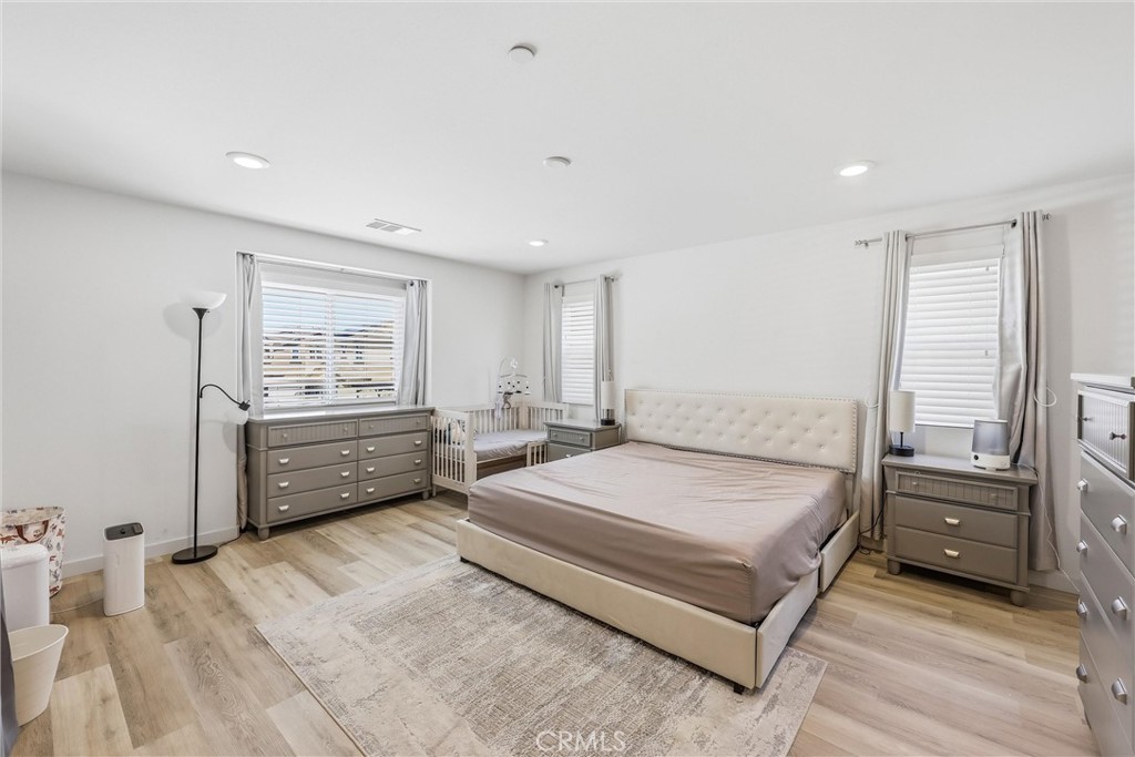 4783 Vanderham Way Eastvale, CA 91752 - Photo 19 of 29 a bedroom with a bed and a large window