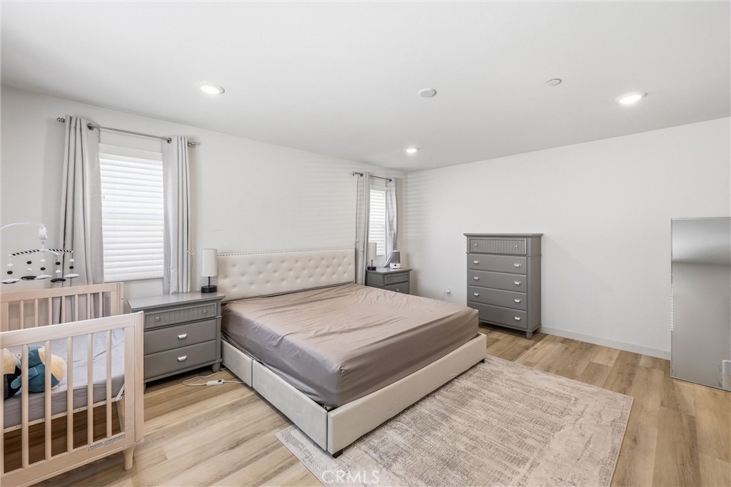 4783 Vanderham Way Eastvale, CA 91752 - Photo 20 of 29 a spacious bedroom with a bed and a large window