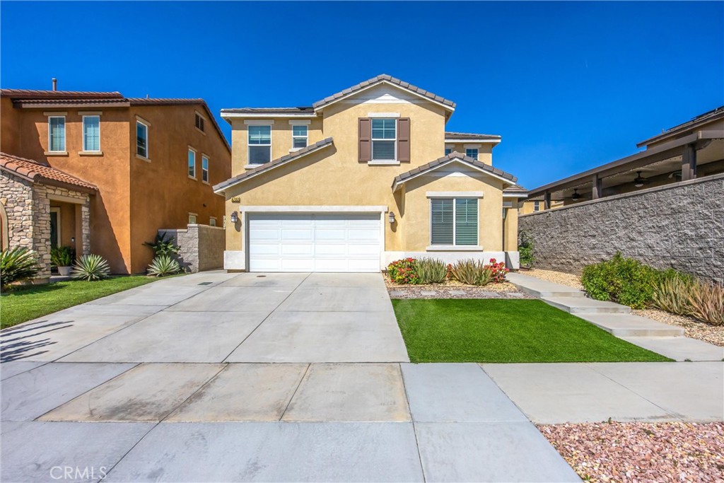 4783 Vanderham Way Eastvale, CA 91752 - Photo 2 of 29 a front view of a house with a yard