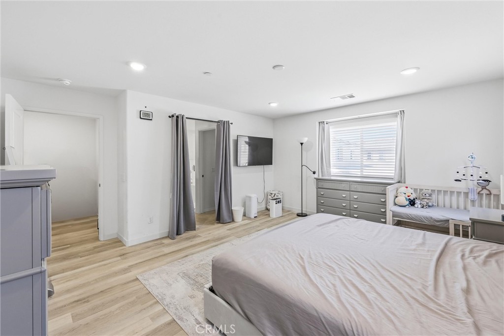 4783 Vanderham Way Eastvale, CA 91752 - Photo 22 of 29 a bedroom with a large bed and a dresser
