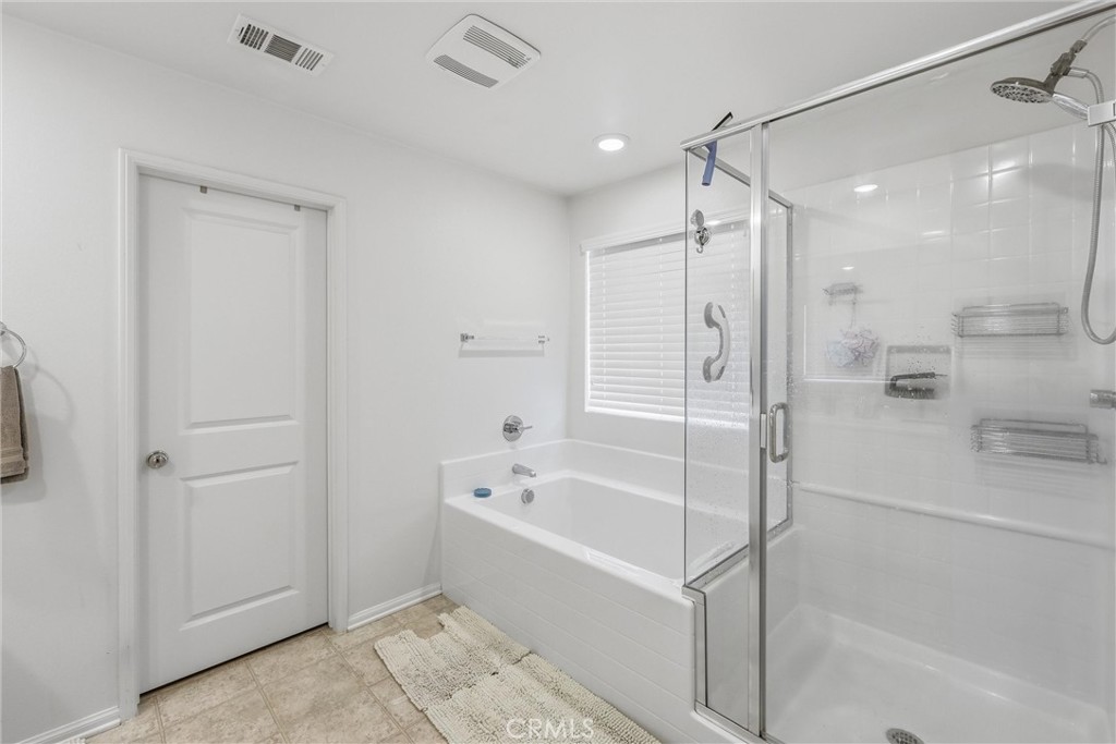 4783 Vanderham Way Eastvale, CA 91752 - Photo 23 of 29 a bathroom with a bathtub shower and a sink