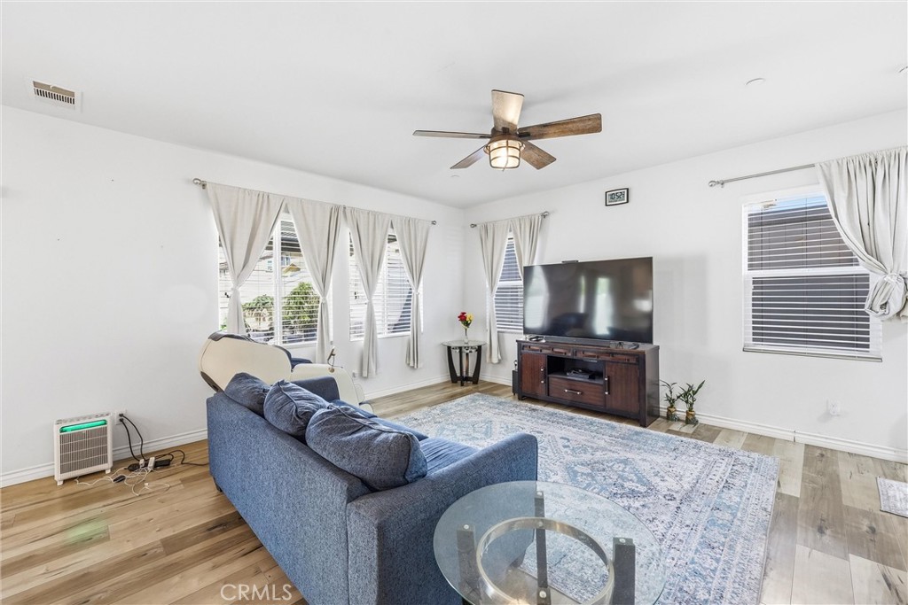 4783 Vanderham Way Eastvale, CA 91752 - Photo 8 of 29 a living room with furniture and a flat screen tv