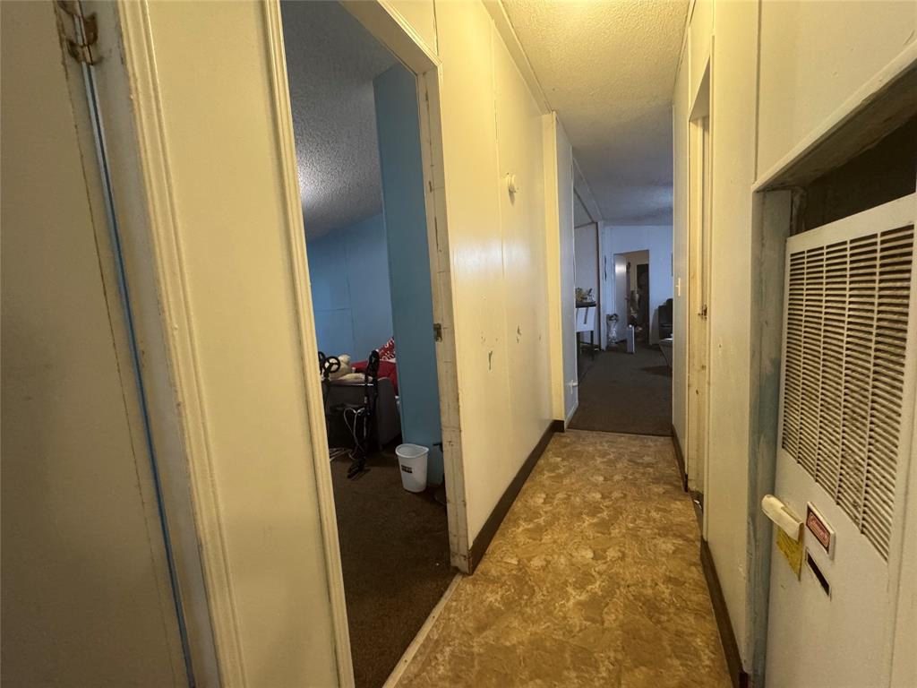 1614 Cole Road Bellmead, TX 76705 - Photo 16 of 21 Hallway featuring panel walls and patterned flooring