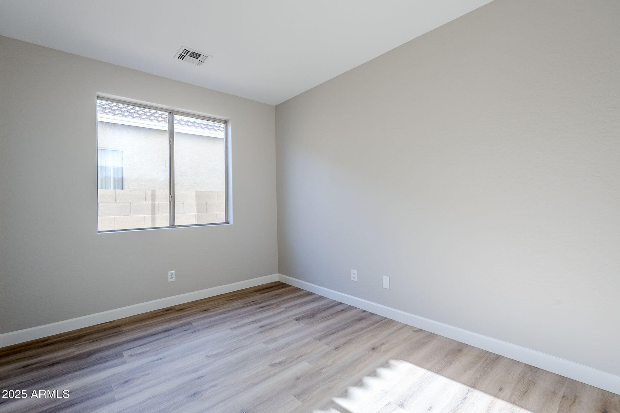 5503 West Carson Road Laveen, AZ 85339 - Photo 44 of 56 wooden floor in an empty room with a window