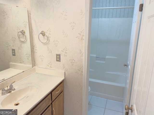 528 Ansley Avenue Perry, GA 31069 - Photo 7 of 9 a bathroom with a granite countertop sink a shower and a mirror