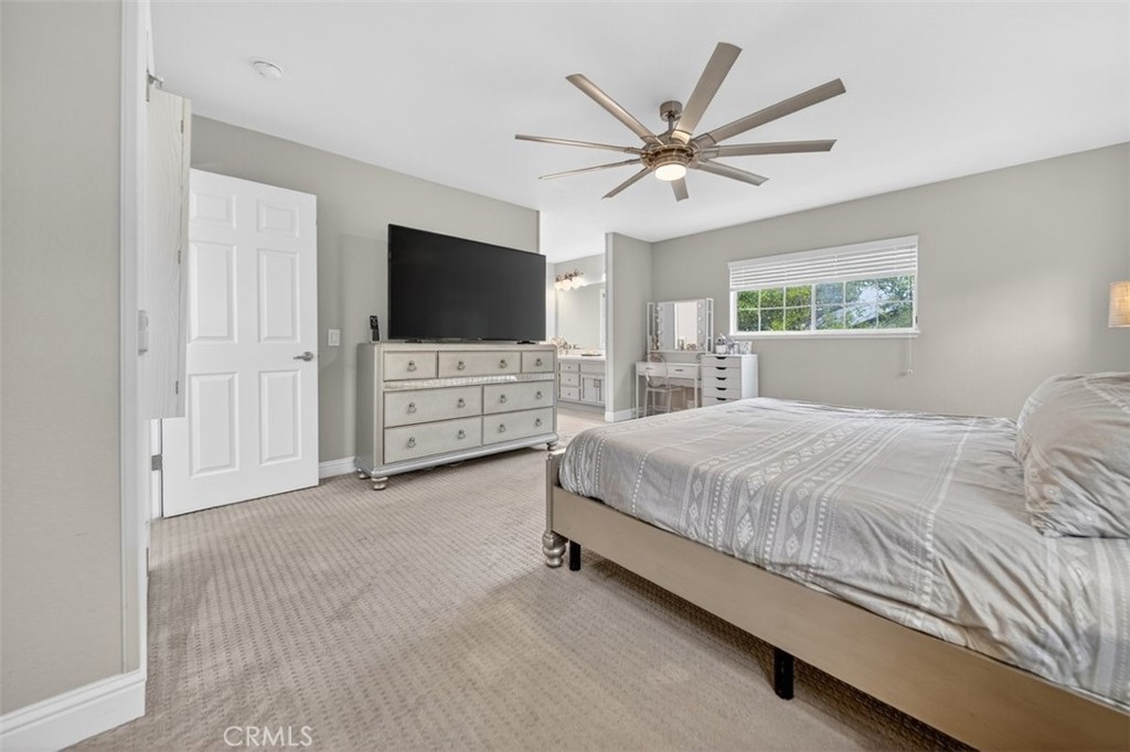 1395 3rd Street Gilroy, CA 95020 - Photo 4 of 39 a spacious bedroom with a bed a flat screen tv and a window