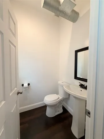 a white toilet sitting next to a bathroom sink