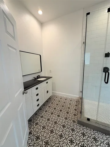 a bathroom with a shower and a mirror