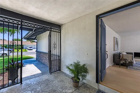 a living room with furniture a fireplace and a floor to ceiling window