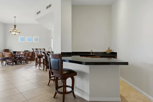 a kitchen with a table and chairs in it