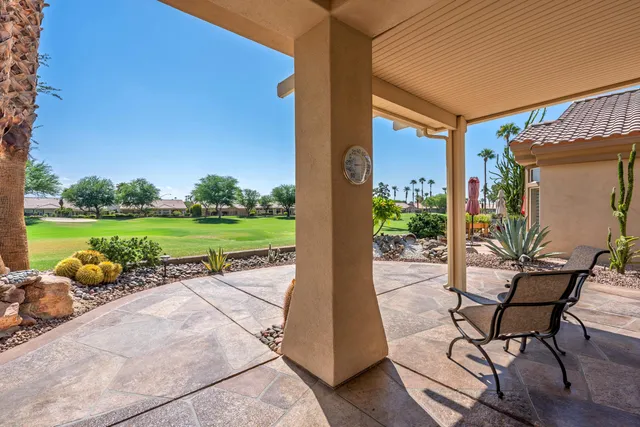 a porch with a table and chairs in patio