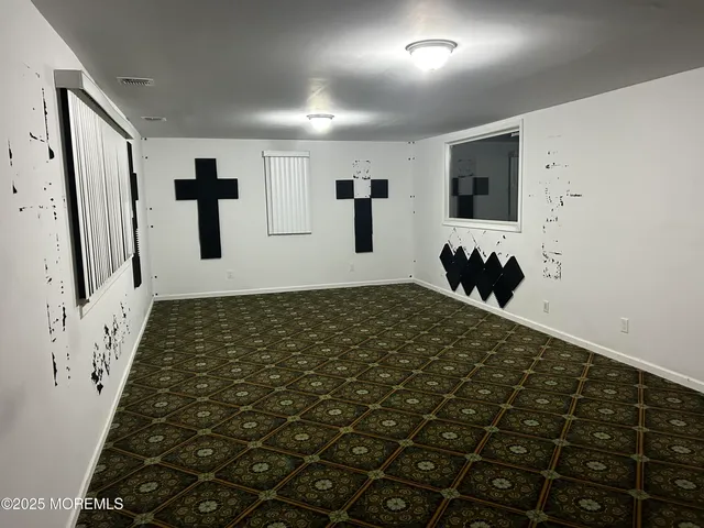 a bathroom with a black and white checkered floor