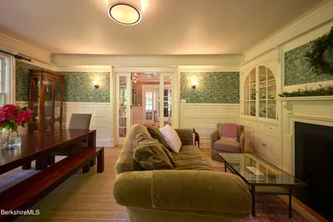a living room with furniture a flat screen tv and a fireplace