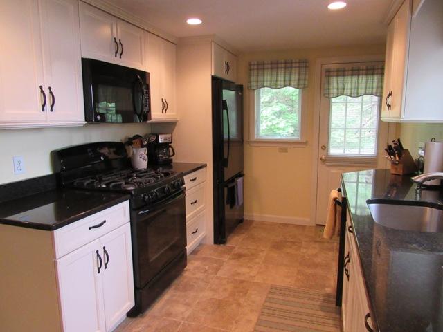 24 Spectacle Pond Road East Wareham, MA 02538 - Photo 15 of 32 a kitchen with granite countertop a stove a sink and a microwave