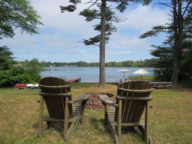 24 Spectacle Pond Road East Wareham, MA 02538 - Photo 3 of 32 a view of a lake with a table and chairs