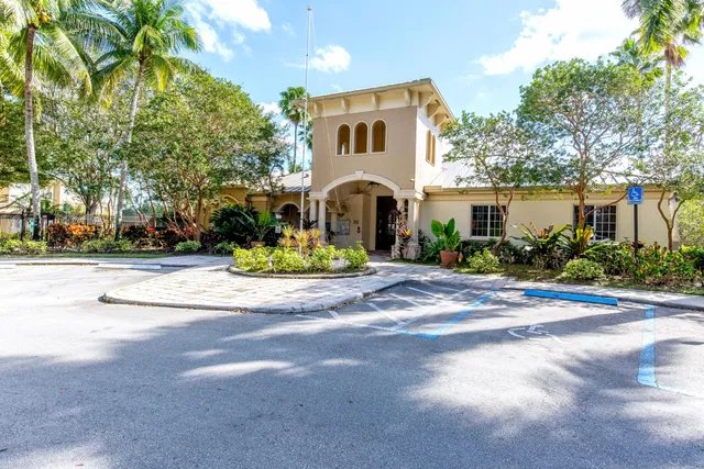 a front view of a house with a yard and a garage