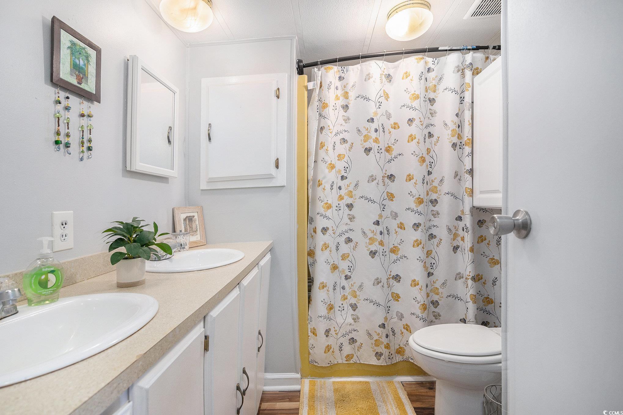 63 Saxon Court Murrells Inlet, SC 29576 - Photo 13 of 22 Living area featuring dark wood-type flooring and a ceiling fan