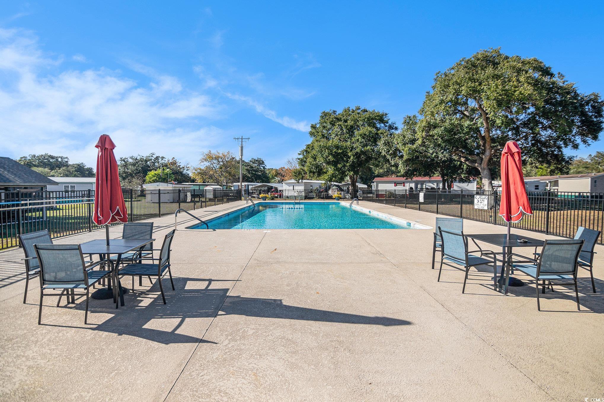 63 Saxon Court Murrells Inlet, SC 29576 - Photo 19 of 22 Community pool featuring a patio area