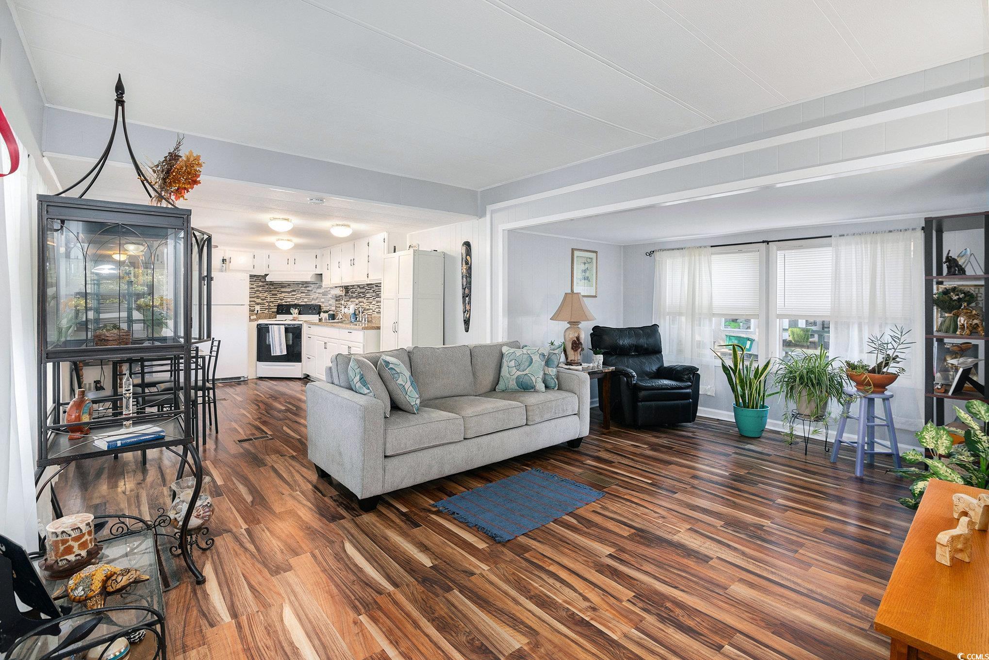 63 Saxon Court Murrells Inlet, SC 29576 - Photo 6 of 22 Living room featuring dark wood-style flooring