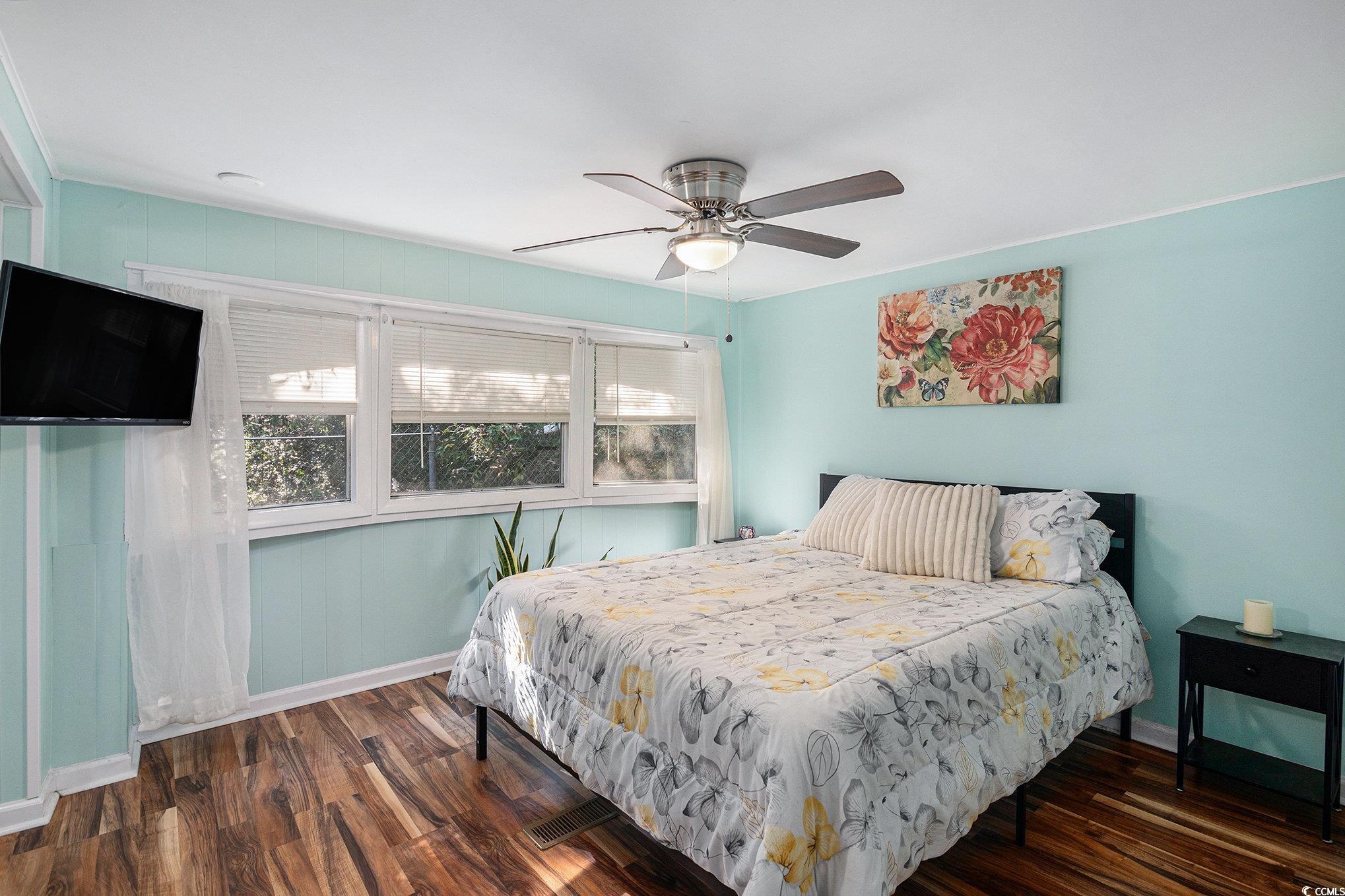 63 Saxon Court Murrells Inlet, SC 29576 - Photo 8 of 22 Living area featuring dark wood-style flooring and wooden walls