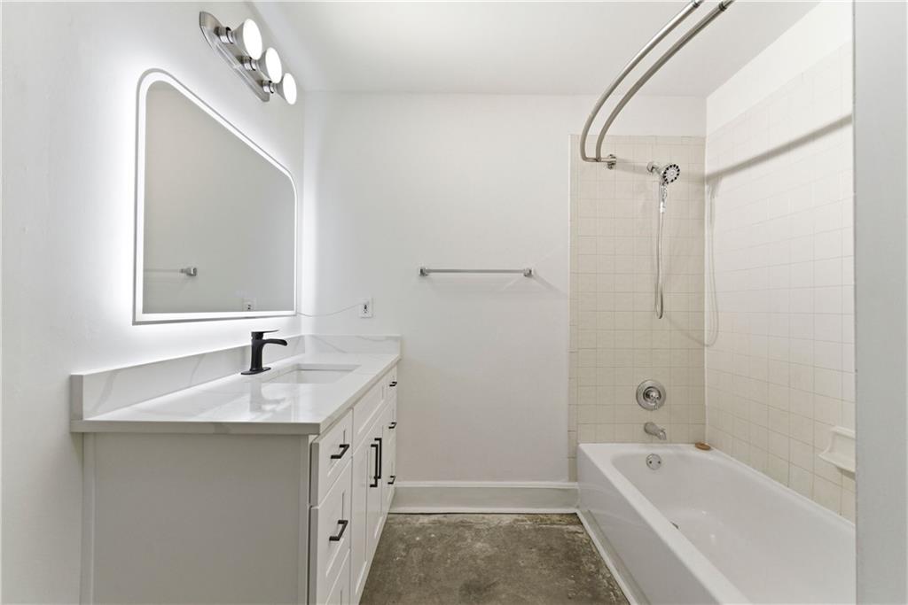 505 Whitehall Street Southwest, Unit 307 Atlanta, GA 30303 - Photo 11 of 35 a bathroom with a tub sink and mirror