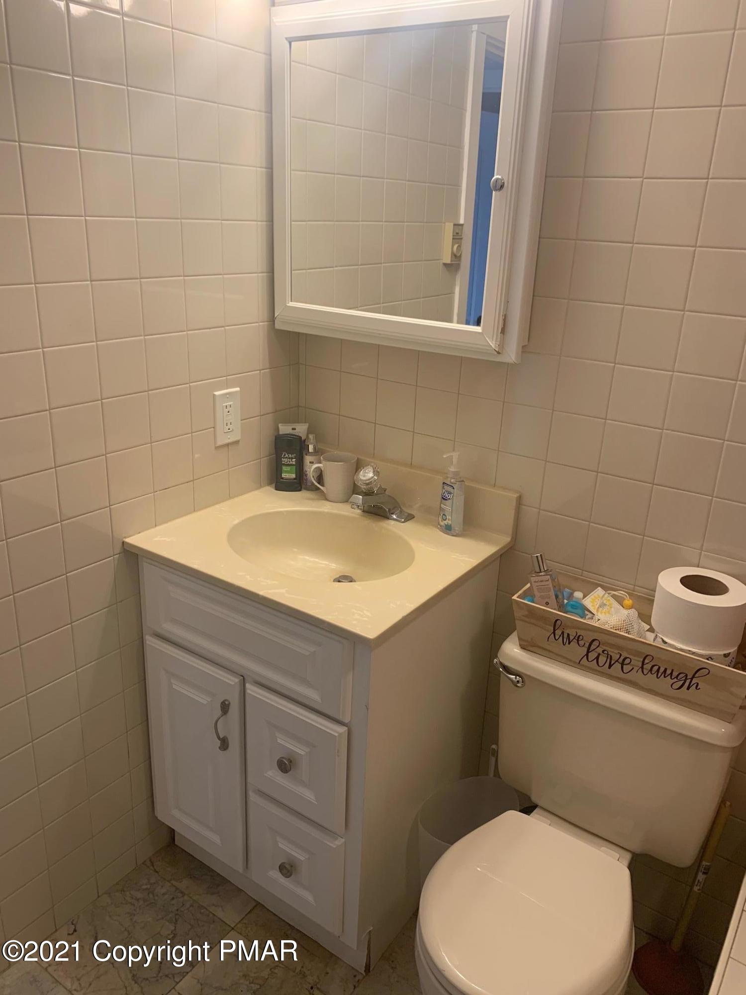 1090 Hampstead Road Bushkill, PA 18324 - Photo 13 of 24 a bathroom with a sink and a toilet