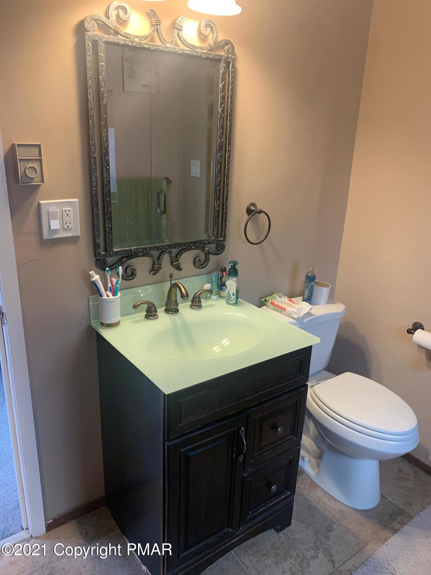 1090 Hampstead Road Bushkill, PA 18324 - Photo 20 of 24 a bathroom with a sink and a mirror