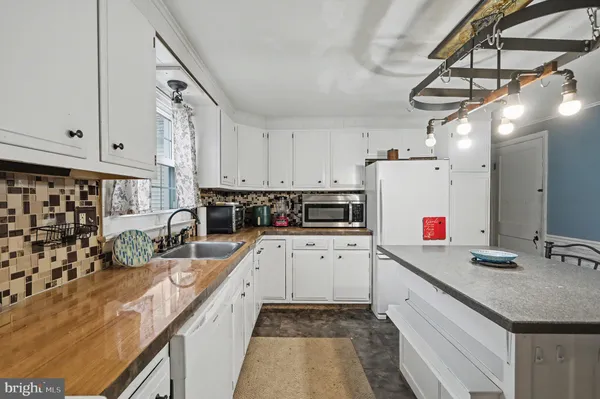 a kitchen with cabinets a sink and appliances