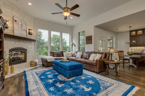 a living room with furniture ceiling fan and a rug
