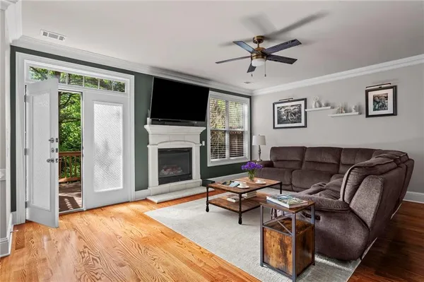 a living room with furniture a fireplace and a flat screen tv