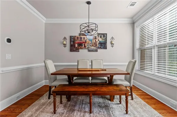 a view of a dining room with furniture window and wooden floor
