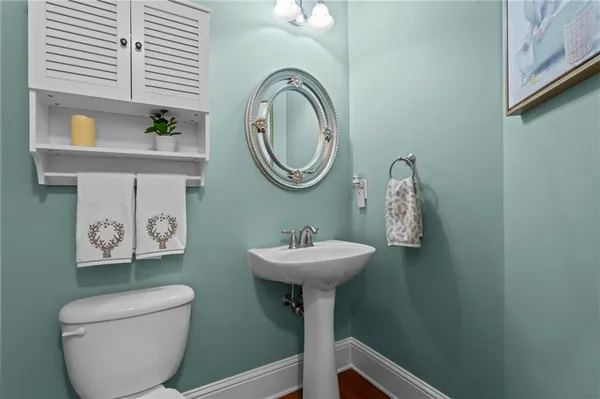 a bathroom with a toilet a sink and a mirror