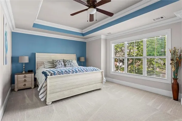 a bedroom with a bed and a large window