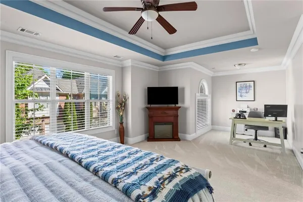 a bedroom with a bed and a large window