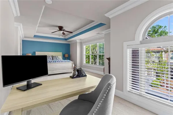 a bedroom with a bed window and flat screen tv