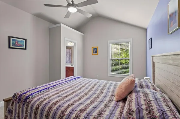 a bedroom with a large bed and a window