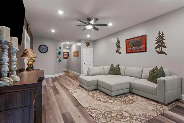 a living room with furniture and a wooden floor