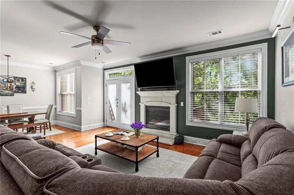 a living room with furniture fireplace and a flat screen tv