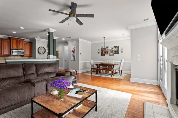 a living room with furniture and kitchen view