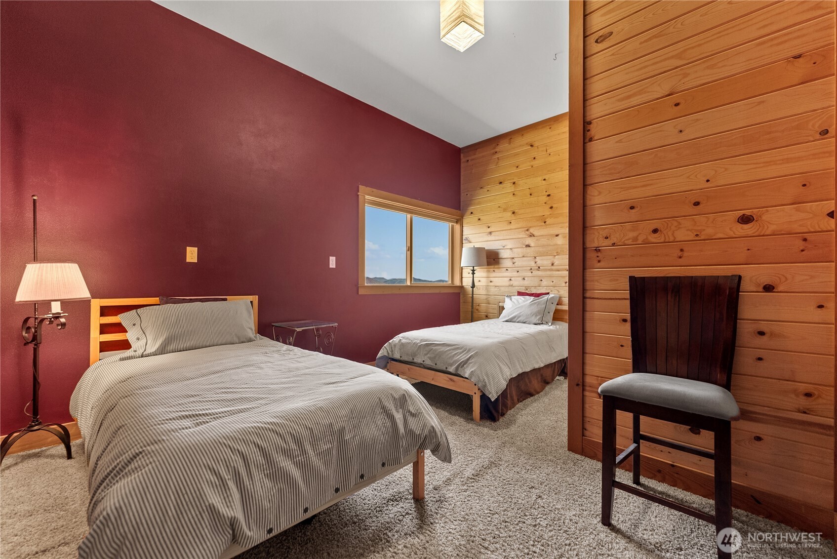 427 Rendezvous Road Winthrop, WA 98862 - Photo 30 of 40 a spacious bedroom with two beds and a fireplace