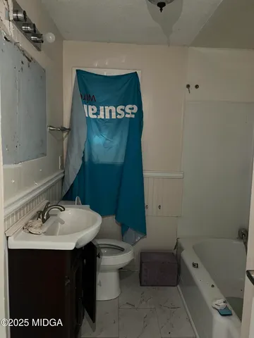 a view of a closet area with wooden floor