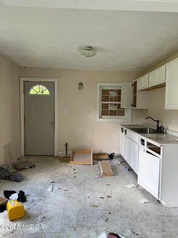a kitchen with a sink and cabinets
