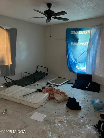 a room with pool table and a ceiling fan