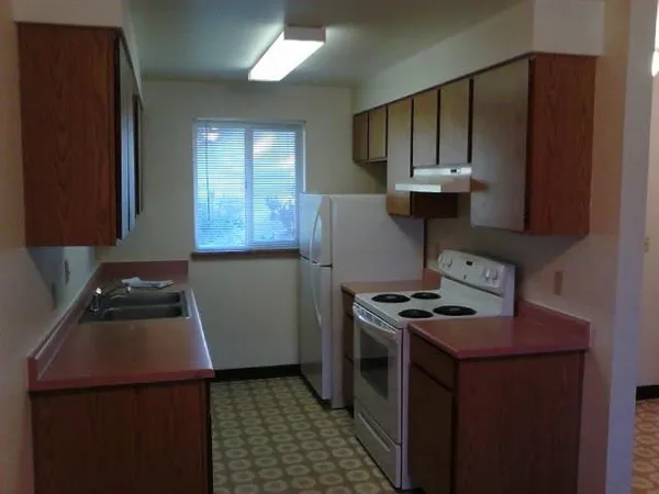 a kitchen with a stove and a refrigerator