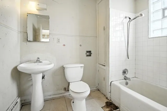 a view of a kitchen with a sink and dishwasher with wooden floor